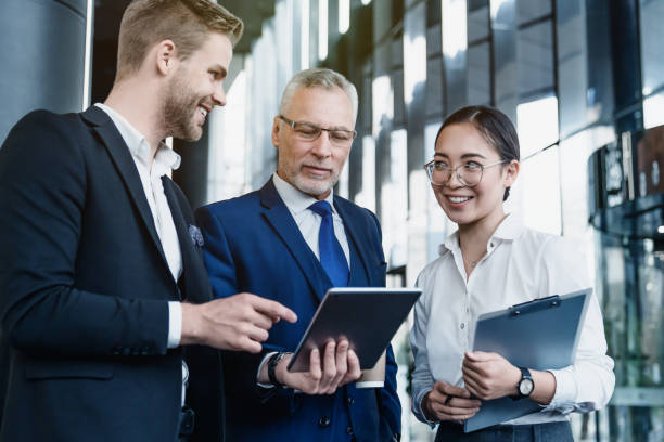 istock Three business professionals discussion over new business plan with look in digital tablet 1186111259