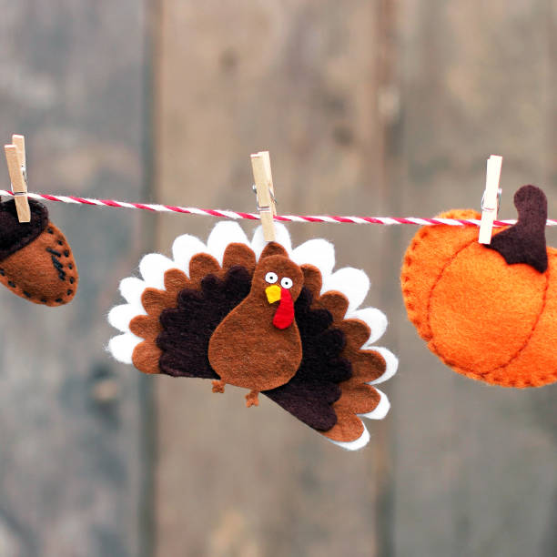 istock Thanksgiving Day. Acorn, pumpkin and turkey on a rope. Composition 1186112874
