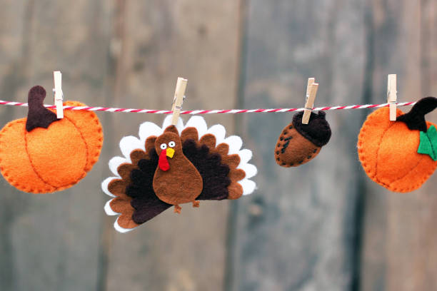 istock Thanksgiving Day. Acorn, pumpkin and turkey on a rope. Composition 1186113123