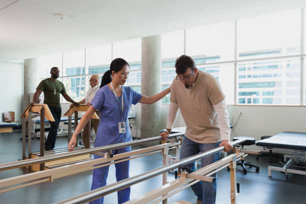 istock Male and female physical therapists work with patients 1186116266