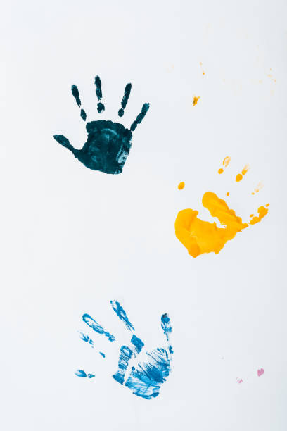 istock yellow, light blue and dark blue hand prints on white 1186117986