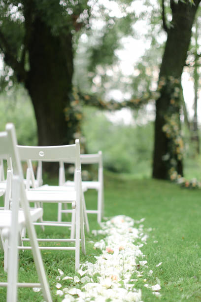 istock White chairs and arh for wedding in park 1186118309