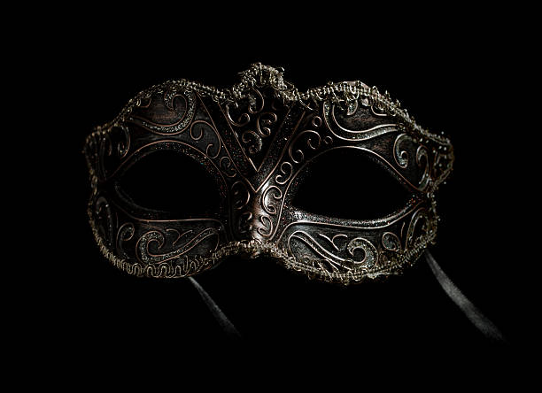 frontal carnival mask on black stock photo