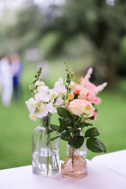 istock Pink flowers in vase on table 1186119121