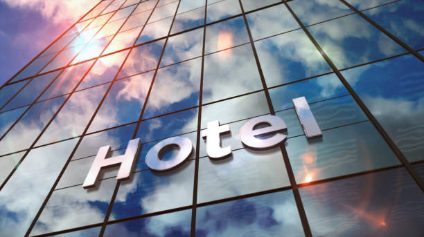 Hotel sign on glass skyscraper. Sky and sun rays mirrored in modern building facade. Travel and tourism concept in 3D rendering illustration.