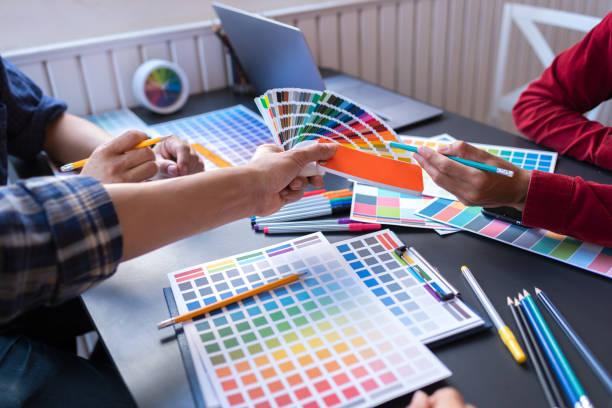 istock Graphic Design Colleagues Choosing Color Swatch For Website Design at Co-working Space Room. 1186119749