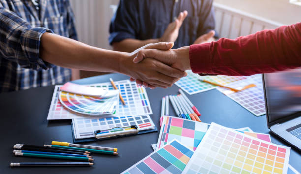 istock Shaking hands after meeting small group of graphic designer friendship in co-working space workplace. 1186119896