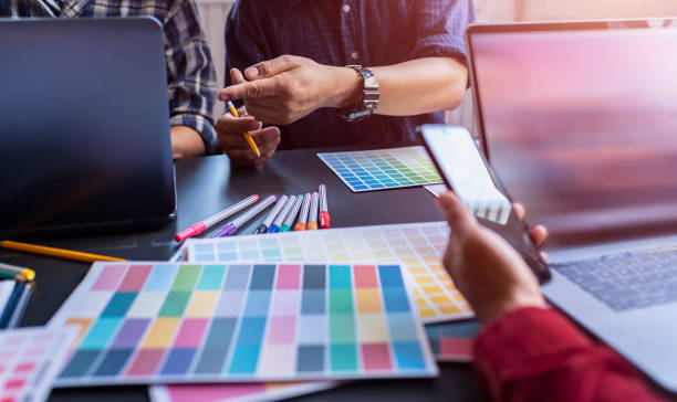 istock Graphic Design Colleagues Choosing Color Swatch For Website Design at Co-working Space Room. 1186120660