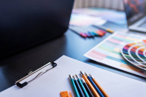 istock Color Swatches with many objects put on black working desk in co-working space room. 1186120774