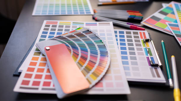 istock Color Swatches with many objects put on black working desk in co-working space room. 1186121084
