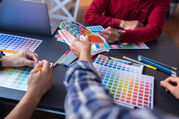 istock Graphic Design Colleagues Choosing Color Swatch For Website Design at Co-working Space Room. 1186121171