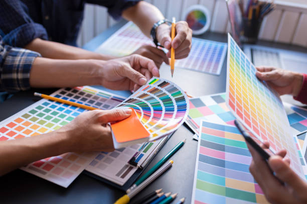 istock Graphic Design Colleagues Choosing Color Swatch For Website Design at Co-working Space Room. 1186121509