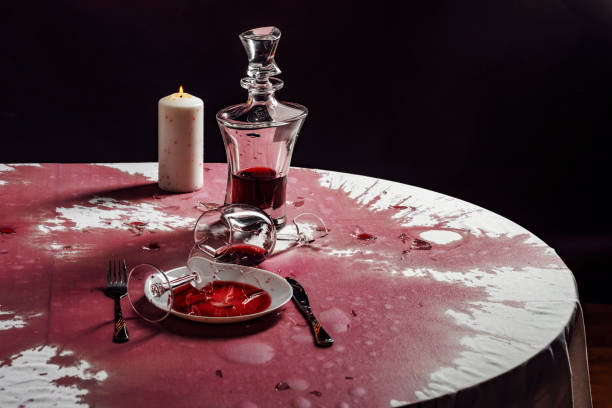 Broken goblets and broken glass on a table filled with red wine. Broken goblets and broken glass on a table filled with red wine broken glass table stock pictures, royalty-free photos & images