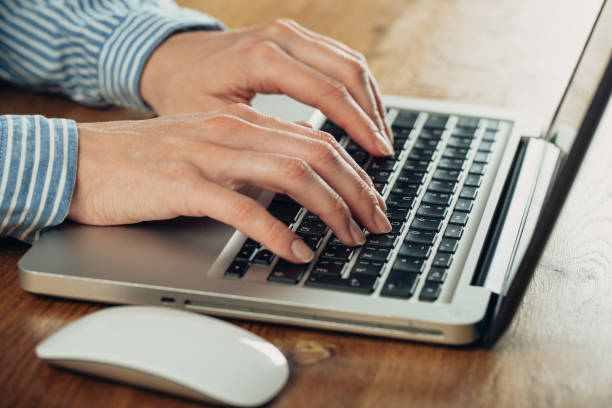 istock Woman using laptop on light table, closeup 1186122360