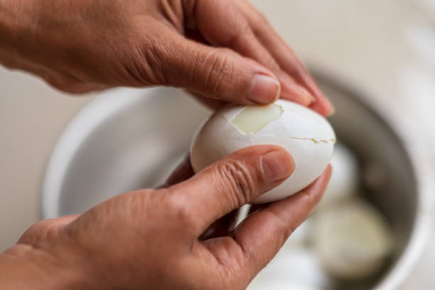 istock Selective Focus Shot Of Peeling A Hard Boiled Egg 1186122596