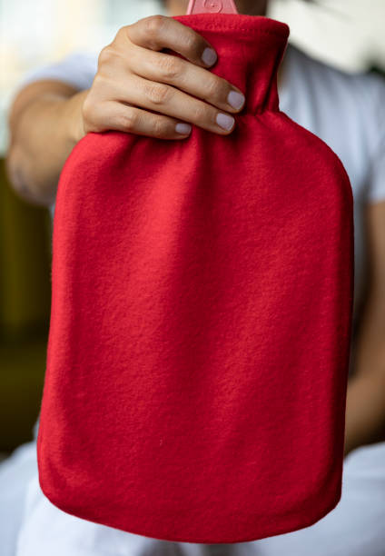 istock Woman Holding Hot Water Bag 1186123112