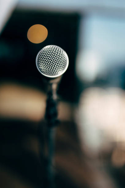 istock MIC ON A STAGE READY FOR THE SINGER OR SPEAKER 1186126335