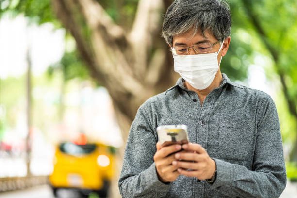 istock Sending selfie to his friends with surgical mask 1186127329