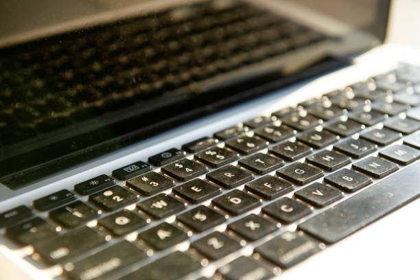 istock keyboard with grey laptop monitors covered in dust 1186127721