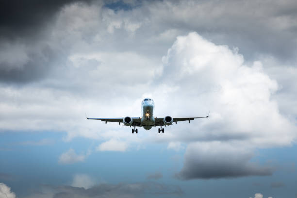 istock Jet airplane flying in the cloudy skies 1186129231