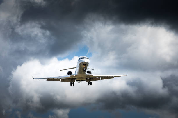 istock Jet airplane flying in the cloudy skies 1186129245