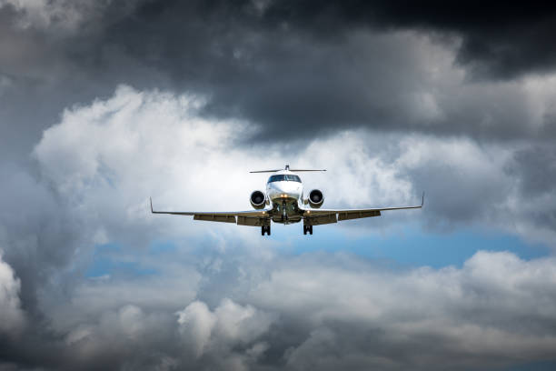 istock Jet airplane flying in the cloudy skies 1186129264