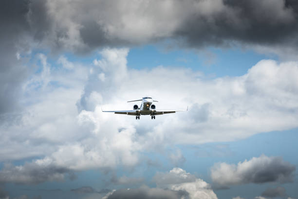 istock Jet airplane flying in the cloudy skies 1186129281