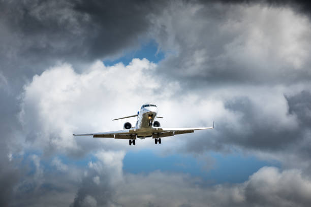 istock Jet airplane flying in the cloudy skies 1186129326