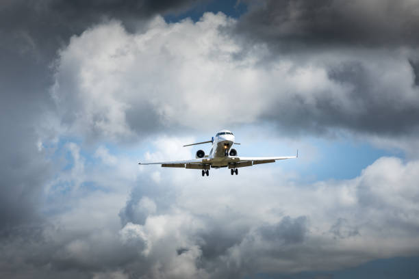 istock Jet airplane flying in the cloudy skies 1186129370