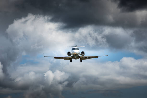 istock Jet airplane flying in the cloudy skies 1186129391