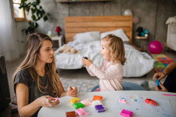 istock Cute blond girl playing with modeling clay 1186129395
