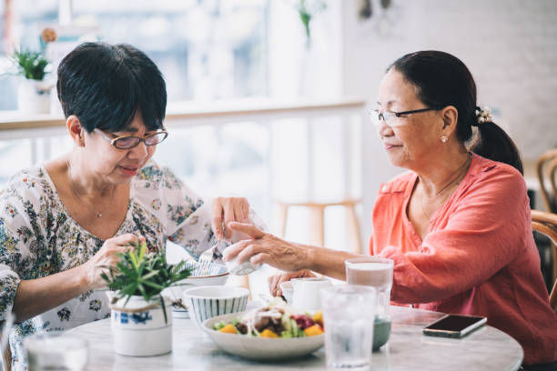 istock Happy Elderly Friend Eating Healthy Together 1186129487