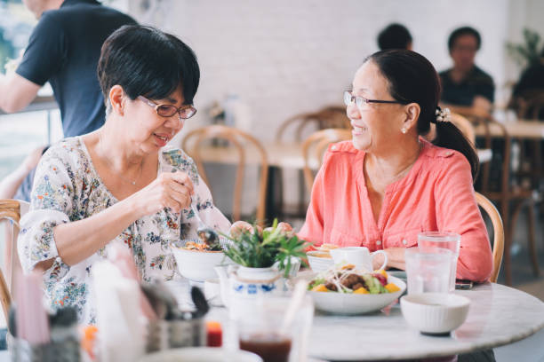 istock Happy Elderly Friend Eating Healthy Together 1186129632