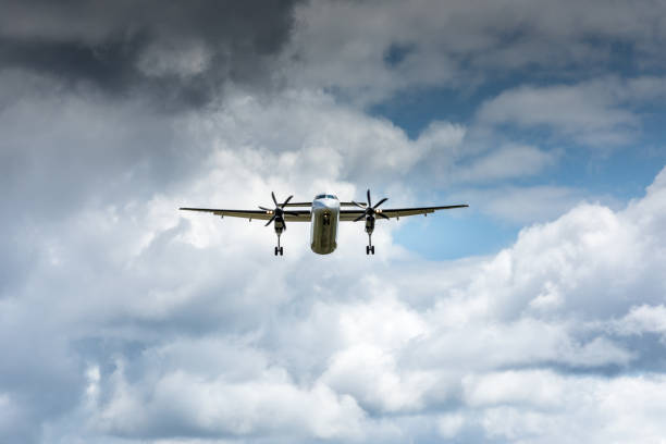 istock Propeller airplane flying in the cloudy skies 1186130376