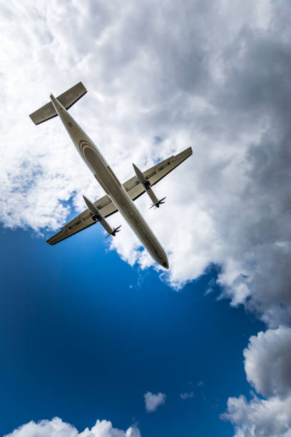 istock Propeller airplane flying in the cloudy skies 1186130393