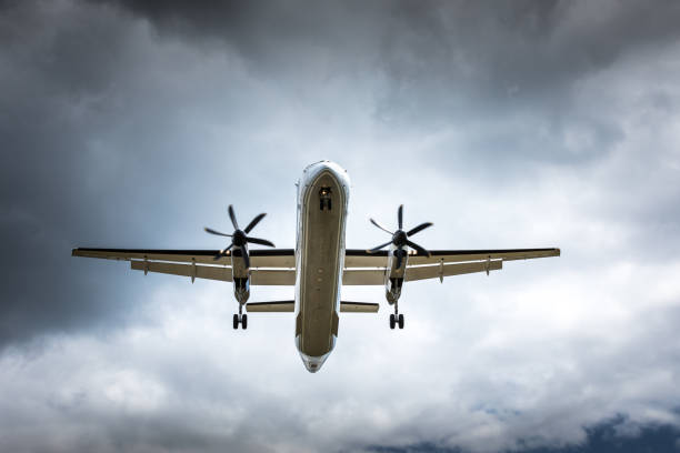 istock Propeller airplane flying in the cloudy skies 1186130569