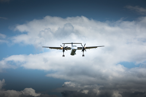 Propeller airplane flying in the cloudy skies