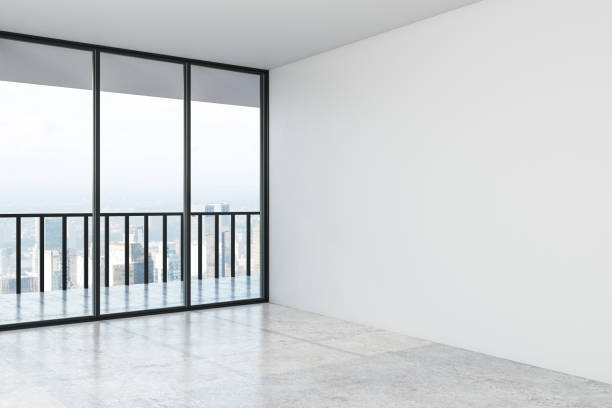 istock Empty modern hall with concrete floor, mock up wall and big window with city view in the afternoon. 1186130793