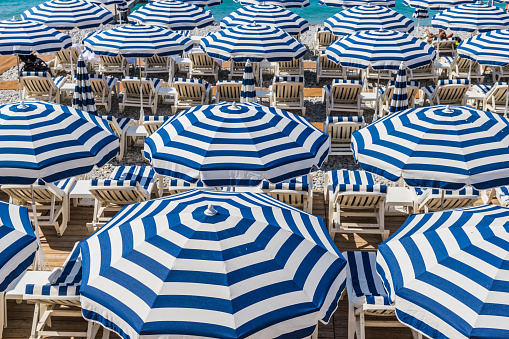 Young adult couple headed to the beach on holiday at a luxury hotel on the Côte d'Azur in South France.