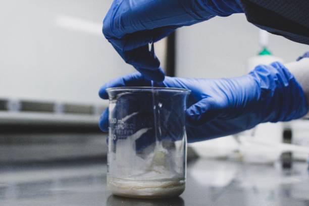 Pharmacy Compounding Example of a lab technician mixing a pharmaceutical compound. pharmaceutical compounding stock pictures, royalty-free photos & images