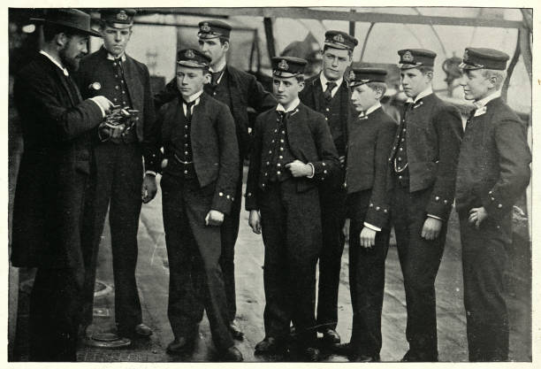Midshipmen and naval cadets learning to use a sextant, 1890s Vintage photograph of Midshipmen and naval cadets learning to use a sextant, (Teaching midshipmen to Shoot the sun), 1890s, 19th Century vintage sailor stock pictures, royalty-free photos & images
