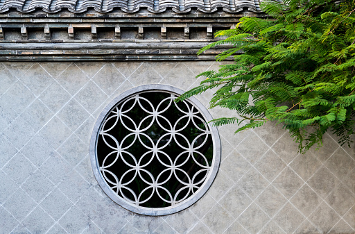 Chinese style window and green tree.