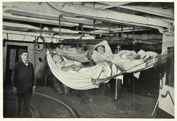 Royal navy sailors sleeping in hammocks, HMS Alexandra, 19th Century Vintage photograph of Royal navy sailors sleeping in hammocks, HMS Alexandra, 19th Century. warship photos stock pictures, royalty-free photos & images