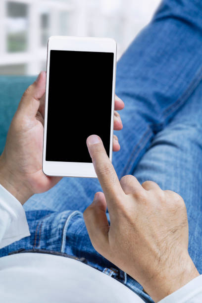 istock Online order and express delivery service food shopping concept on touch screen which hand's man holding smart phone lying on sofa at home background. Lifestyle in city. 1186136492