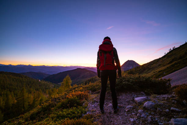 istock moonlight blues, single woman standing in mountains in twilight 1186136575