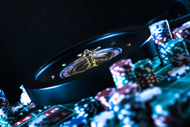 Casino background, poker Chips on gaming table, roulette wheel in motion,