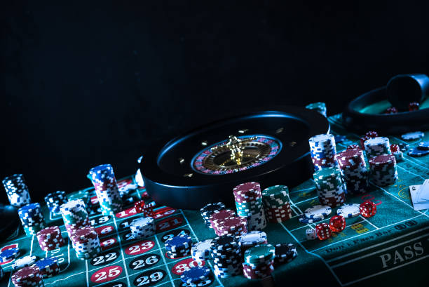 istock Casino background, poker Chips on gaming table, roulette wheel in motion, 1186137543