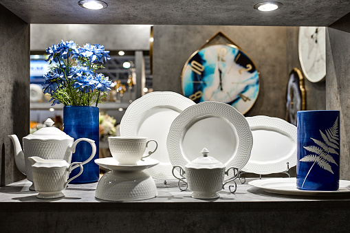 a showcase with the laying of porcelain dishes. Beautiful merchandising, dishes for restaurants and hotels.