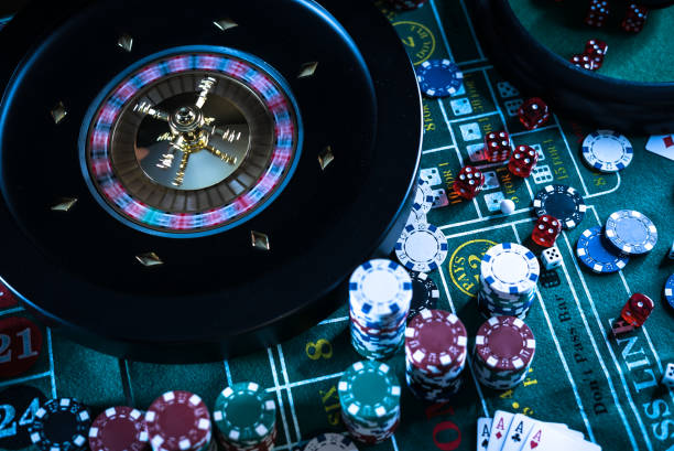 istock Casino background, poker Chips on gaming table, roulette wheel in motion, 1186138939