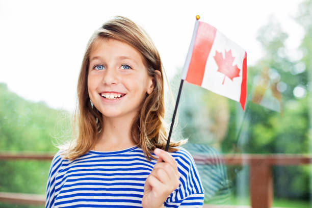 Canada Day Celebration young girl holding a Canadian flag victoria day canada photos stock pictures, royalty-free photos & images